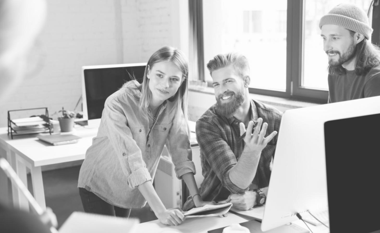 Students collaborating on web development projects in a modern learning environment